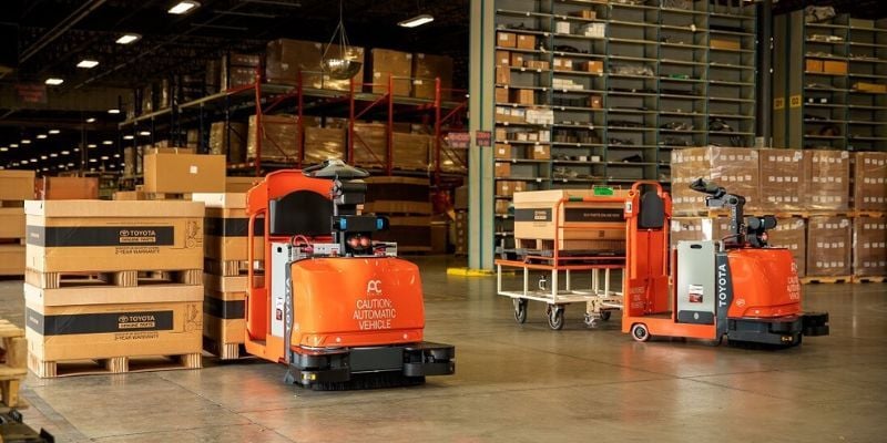 Automated guided vehicles transporting pallets in a warehouse