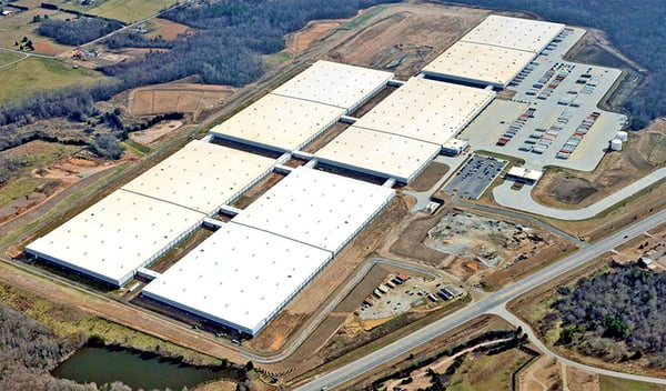 Exterior view of Michelin’s U70 Distribution Center in Woodruff, South Carolina, showcasing the expansive warehouse surrounded by greenery and logistics infrastructure.