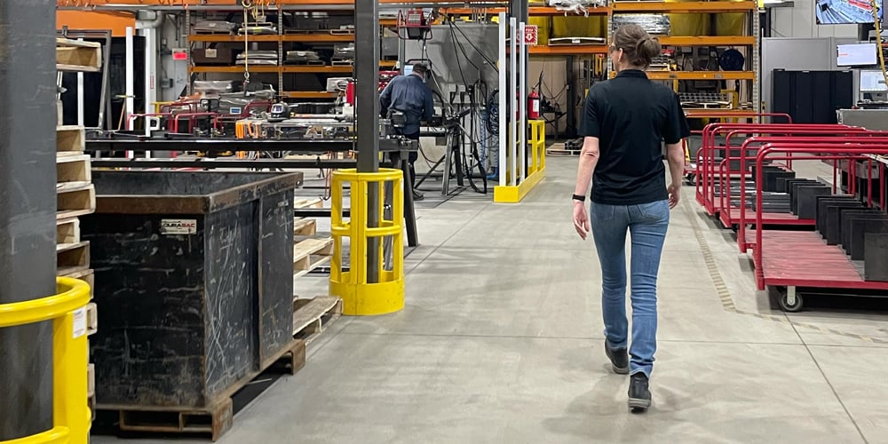 Damotech’s Chief Operating Officer doing her morning rounds on the warehouse floor, greeting team members, and checking rack safety and production flow.