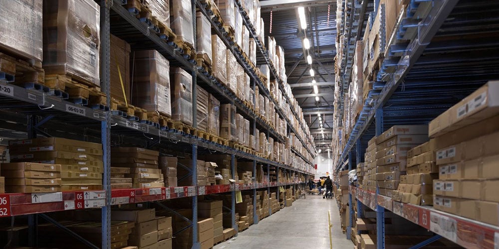 Warehouse pallet racks in a warehouse aisle