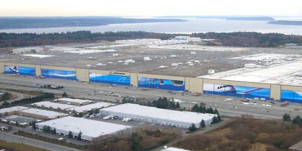 Aerial view of Boeing’s Everett Factory in Washington, featuring the massive assembly building with adjacent aircraft, parking lots, and support facilities.