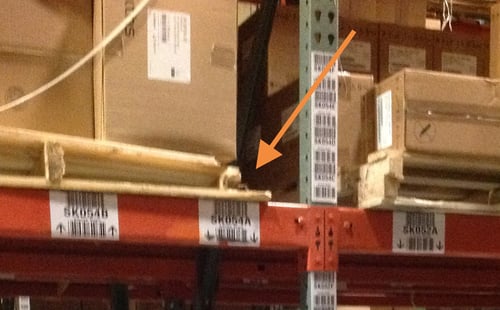 Broken or cracked wood pallet used in a pallet rack system