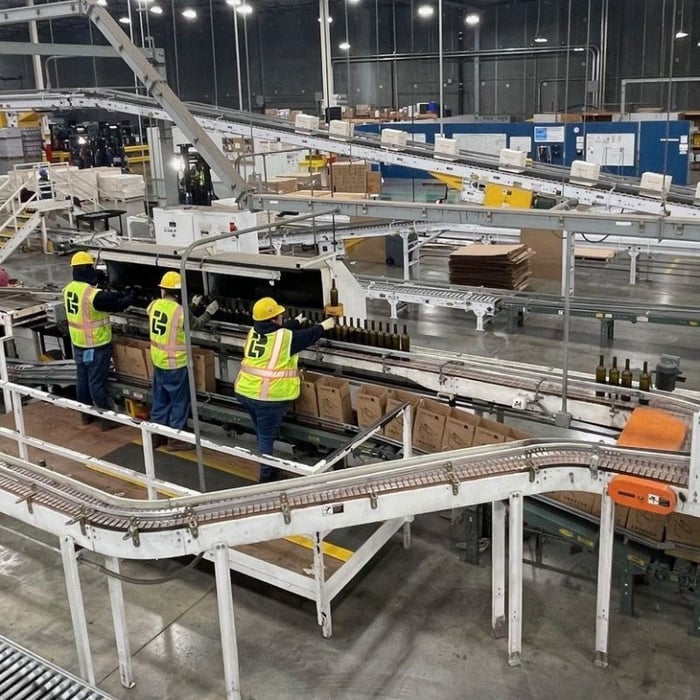 Automated wine distribution center operated by Buske Logistics, featuring conveyors and high-density racking for streamlined storage and order fulfillment.