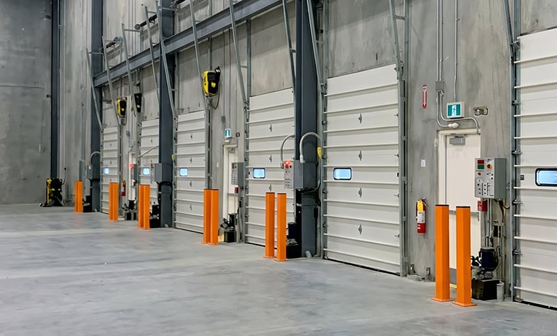 Safety bollards used to protect warehouse dock doors