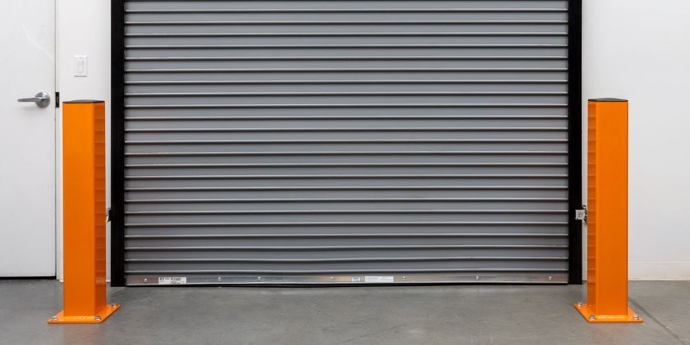 Safety bollards installed in front of a warehouse dock door