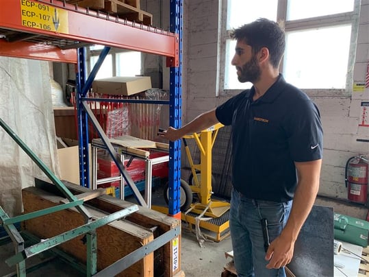 Jean-Paul Khalil, CEP, inspecting a rack in a warehouse