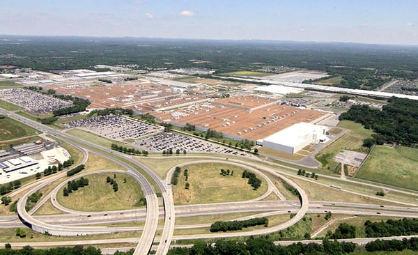 Aerial view of Nissan’s Smyrna Assembly Plant in Tennessee, featuring expansive warehouse buildings, surrounding parking lots, and the on-site test track.
