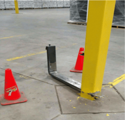Steel building column pierced and sheared by a forklift fork