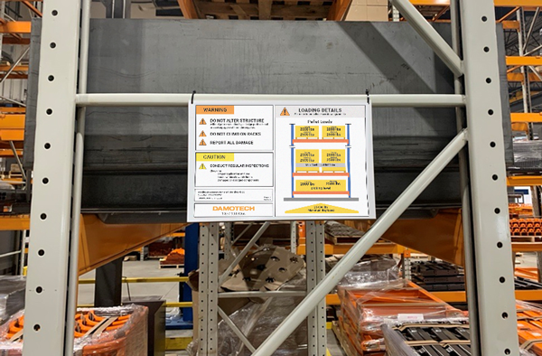 Load capacity plaque on a rack brace