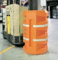 Orange plastic column guard wrapped around a warehouse column