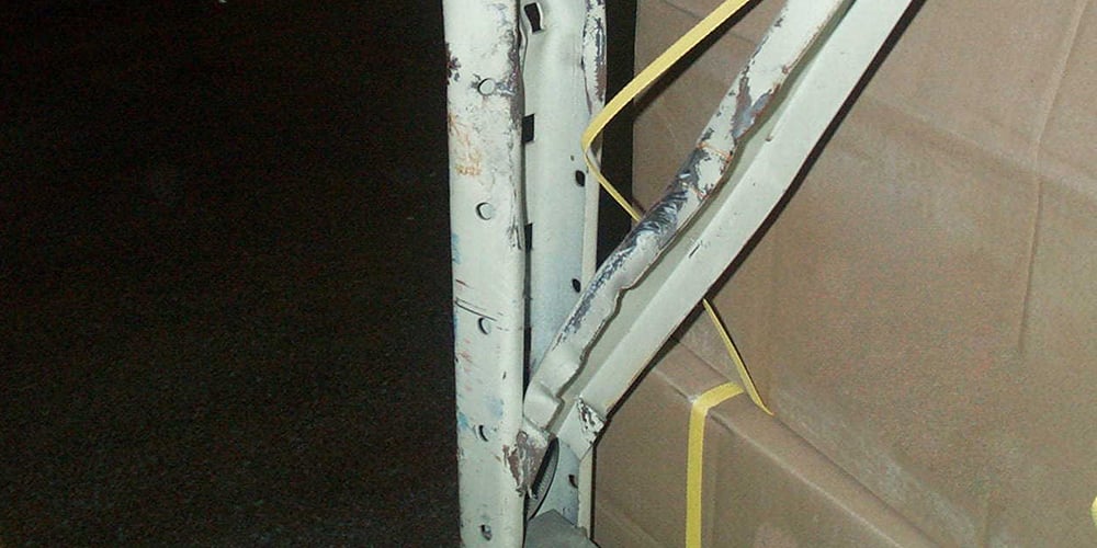 Damaged pallet rack bay flagged by priority level during a rack inspection