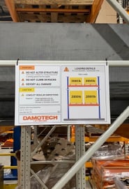 Rack load capacity label on a pallet rack brace