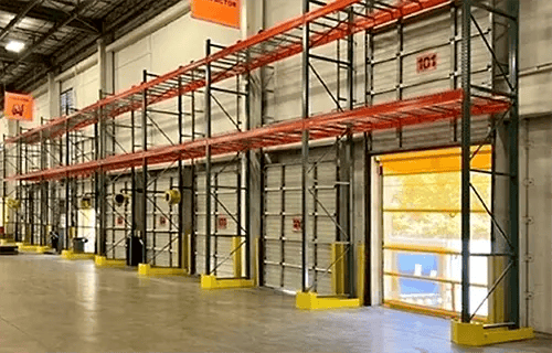 DAMO FRAME GUARD protecting a rack frame beside a warehouse dock door