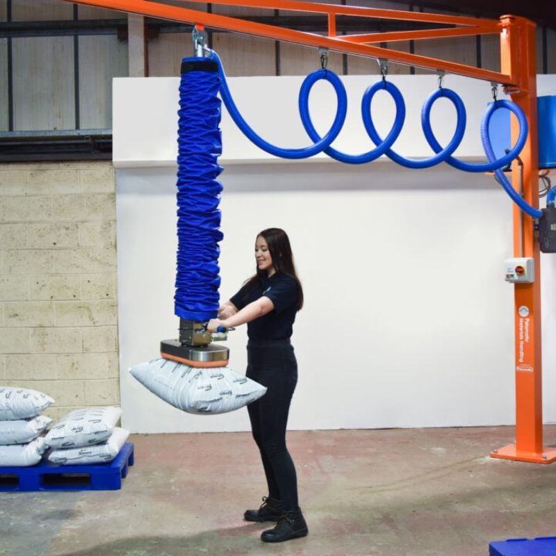 Operator using a vacuum lifter to handle a large panel