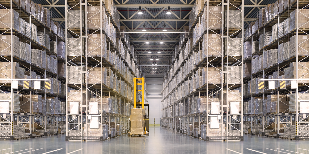 Forklift between tall warehouse rack systems