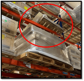 a pallet that has fallen between its supporting beams