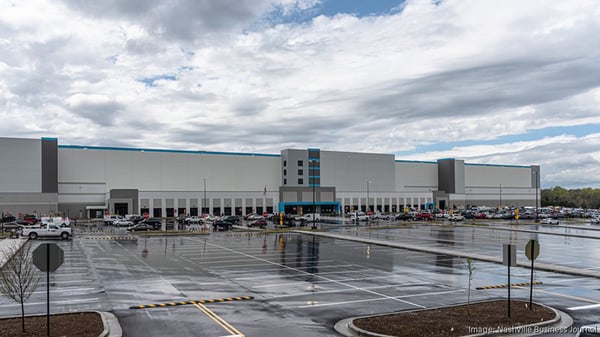 Wide-angle view of Amazon’s Mt. Juliet Fulfillment Center in Tennessee, highlighting the multi-level warehouse structure and surrounding parking lot.