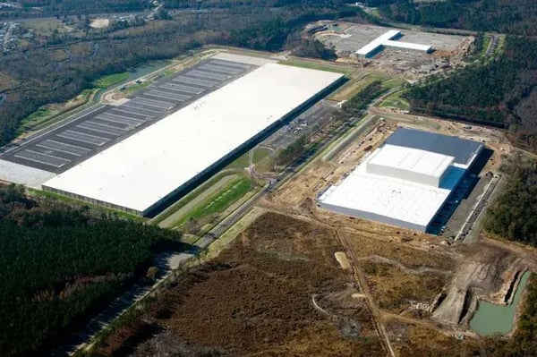 Aerial view of Target’s 2 million sq. ft. import warehouse near the Port of Savannah, Georgia, with multiple truck bays and shipping containers visible.