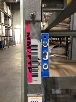 Using torpedo level to check rack verticality