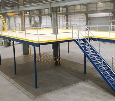 A platform with a stairwell in a warehouse