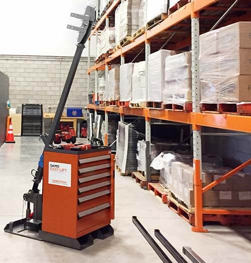 Damo Easy Lift Lifting device in a warehouse in front of racking