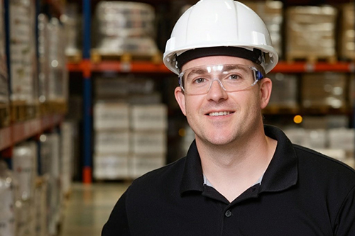 Doug posing in a warehouse