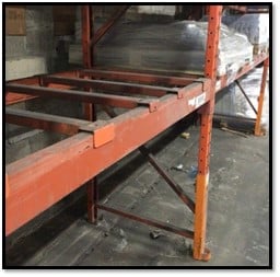 Pallet rack safety bars that are not properly attached to the beam.